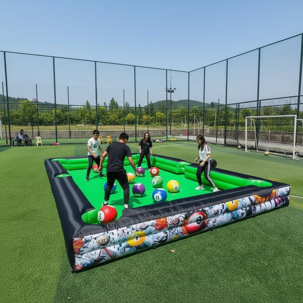 Inflatable pool table with colorful design on a grassy field