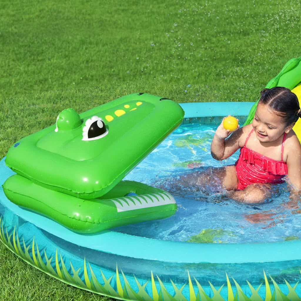 Child playing with an inflatable crocodile pool toy in a backyard pool.